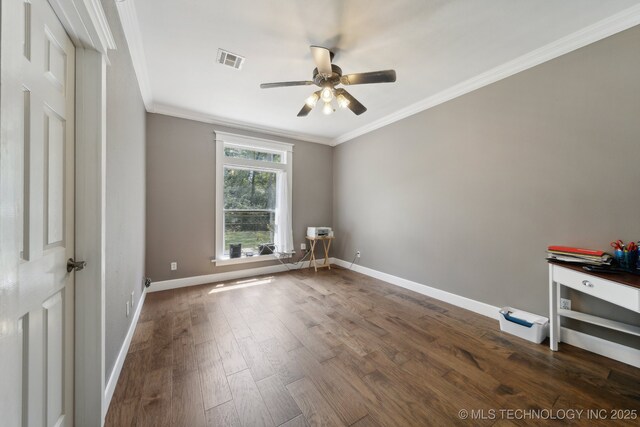 unfurnished bedroom with a ceiling fan, baseboards, visible vents, dark wood-style floors, and crown molding