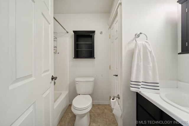 full bathroom featuring tile patterned flooring, toilet, vanity, baseboards, and washtub / shower combination