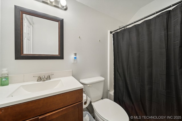 full bath with lofted ceiling, vanity, and toilet