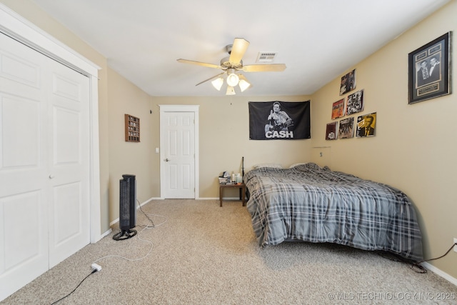 carpeted bedroom featuring a ceiling fan, visible vents, and baseboards