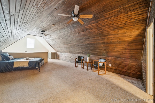 unfurnished bedroom featuring carpet floors, lofted ceiling, a ceiling fan, wood ceiling, and wood walls