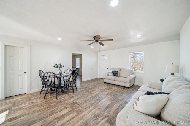 living room with baseboards, ceiling fan, wood finished floors, and recessed lighting