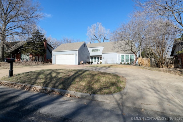 view of front facade with a garage and concrete driveway