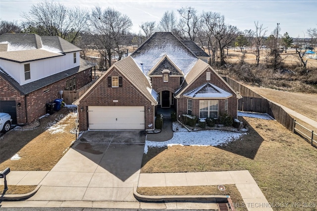 traditional-style home with a garage, brick siding, a shingled roof, fence, and concrete driveway