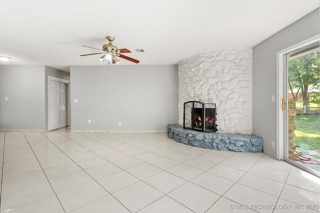 unfurnished living room featuring a ceiling fan, tile patterned flooring, visible vents, and a fireplace