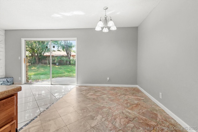 interior space featuring baseboards and an inviting chandelier