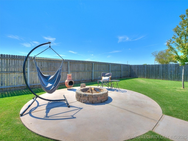 view of patio featuring a fenced backyard and a fire pit