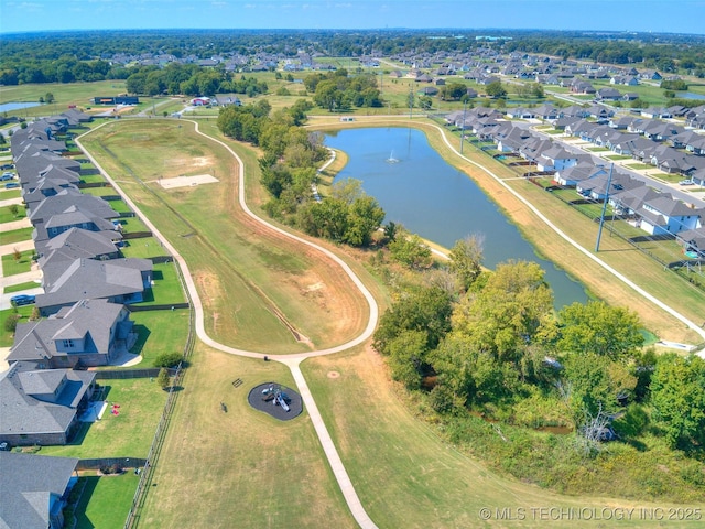 drone / aerial view featuring a residential view and a water view