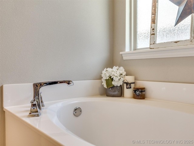 bathroom with a garden tub