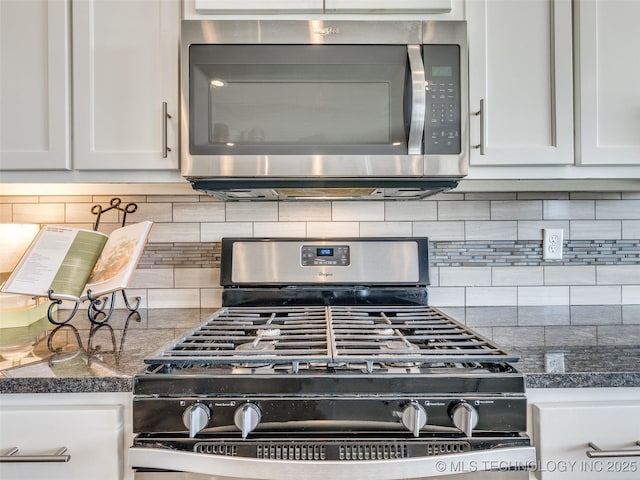 kitchen with appliances with stainless steel finishes, white cabinetry, and decorative backsplash