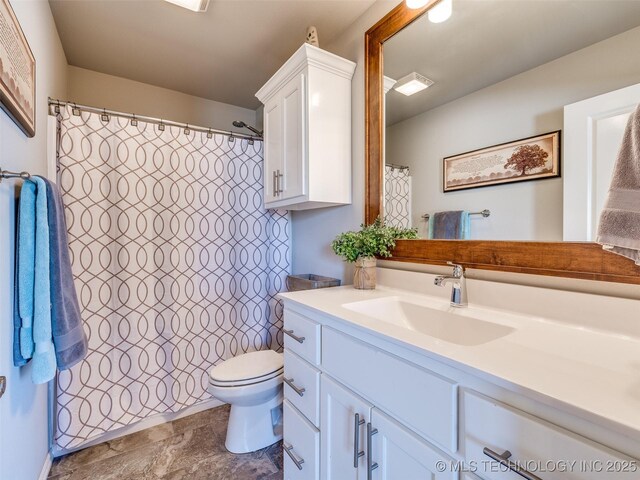 full bathroom featuring toilet, stone finish floor, visible vents, and vanity