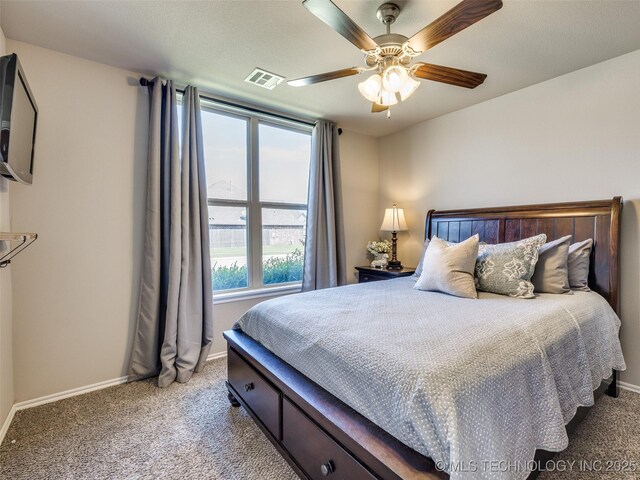 carpeted bedroom featuring visible vents, ceiling fan, and baseboards