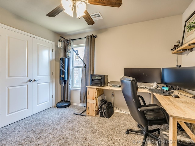 carpeted office featuring ceiling fan and visible vents