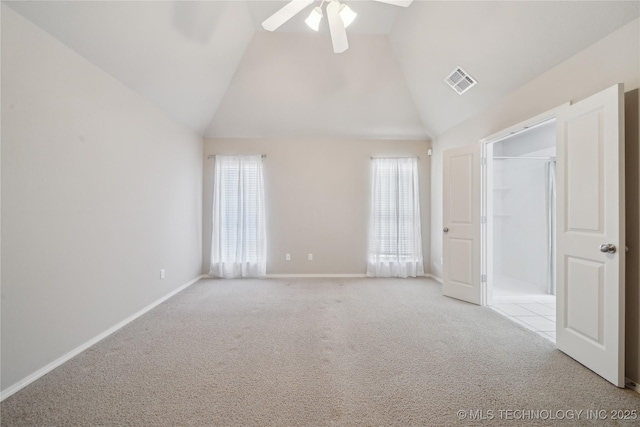 spare room featuring baseboards, visible vents, ceiling fan, carpet flooring, and high vaulted ceiling