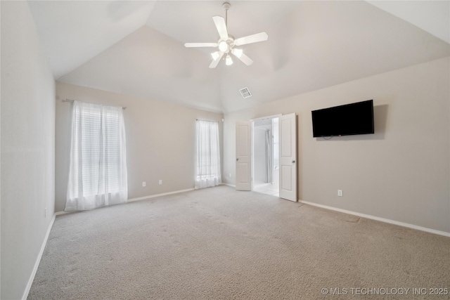 interior space featuring visible vents, vaulted ceiling, light carpet, and baseboards