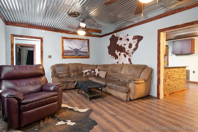 living room with ceiling fan, wood finished floors, and visible vents