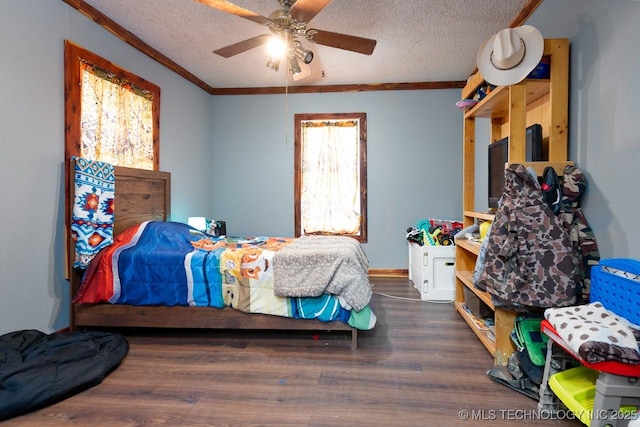 bedroom featuring ornamental molding, a ceiling fan, a textured ceiling, and wood finished floors