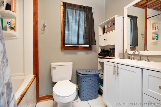 bathroom featuring a tub to relax in, toilet, vanity, tile patterned floors, and walk in shower