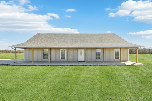2374 N 205th Rd, Beggs, OK 74421 - rear view of house featuring roof with shingles, a yard, and covered porch