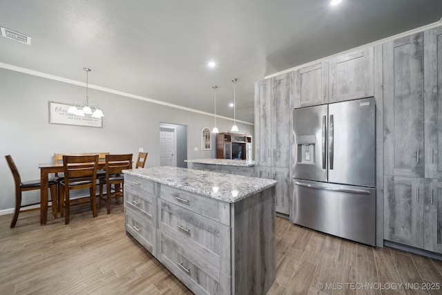 2374 N 205th Rd, Beggs, OK 74421 - kitchen featuring stainless steel fridge with ice dispenser, light wood-style floors, crown molding, a center island, and hanging light fixtures