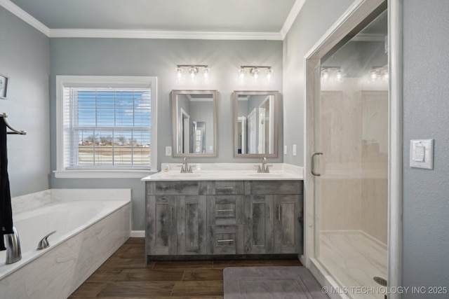 2374 N 205th Rd, Beggs, OK 74421 - bathroom with wood finished floors, crown molding, a garden tub, double vanity, and a shower stall