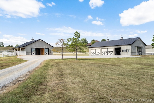 view of yard with an outbuilding, an exterior structure, and a detached garage