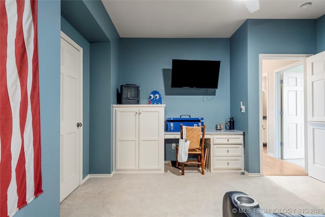 home office with light carpet and baseboards