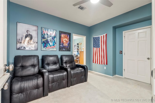 carpeted home theater featuring visible vents, a ceiling fan, and baseboards