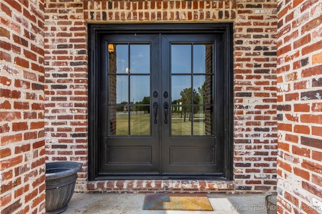 property entrance with french doors and brick siding