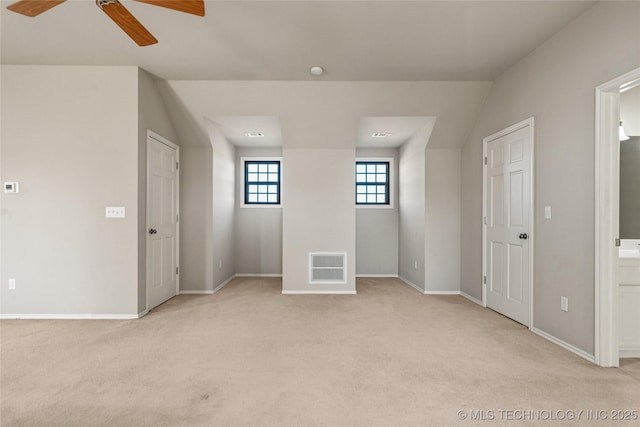 spare room featuring visible vents, ceiling fan, light carpet, and baseboards