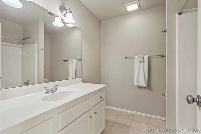 full bathroom featuring visible vents, vanity, tile patterned flooring, baseboards, and walk in shower