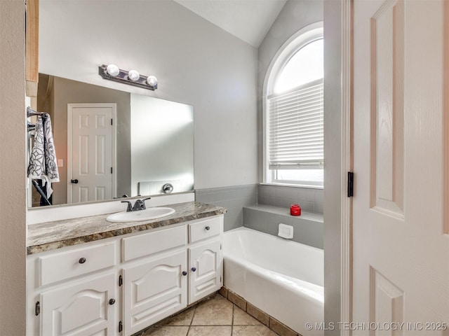 full bath with vanity, a bath, and tile patterned floors