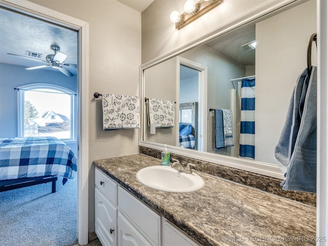 full bathroom featuring visible vents, ceiling fan, and vanity