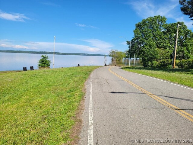 305 Mcgee St, Eufaula, OK 74432 - view of asphalt street featuring a water view and street lights