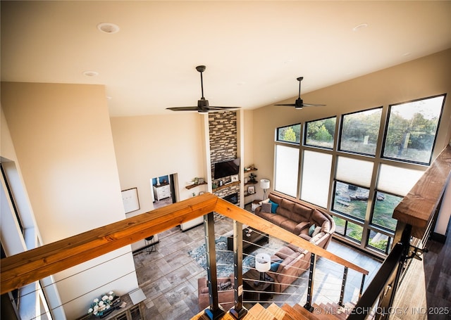 living room with ceiling fan and a wealth of natural light