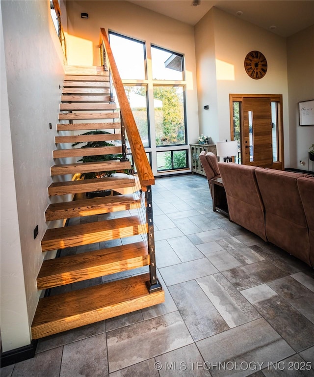 staircase with a high ceiling