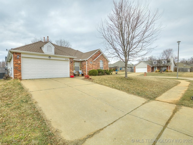 view of front of house featuring driveway, an attached garage, roof with shingles, and brick siding