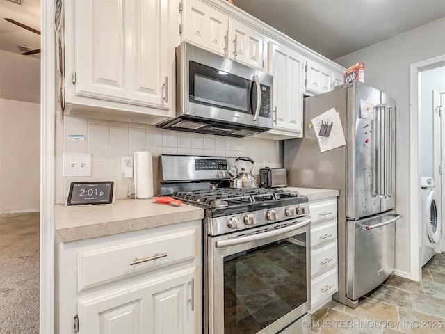 kitchen with stainless steel appliances, light countertops, white cabinetry, and decorative backsplash