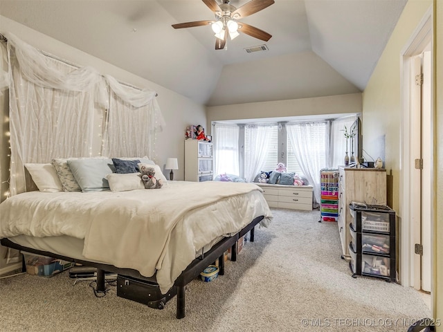 bedroom with light carpet, visible vents, vaulted ceiling, and a ceiling fan