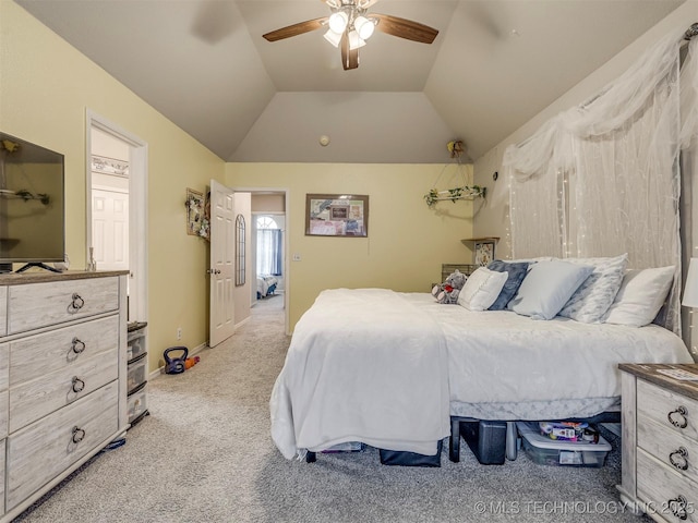 carpeted bedroom with lofted ceiling and a ceiling fan