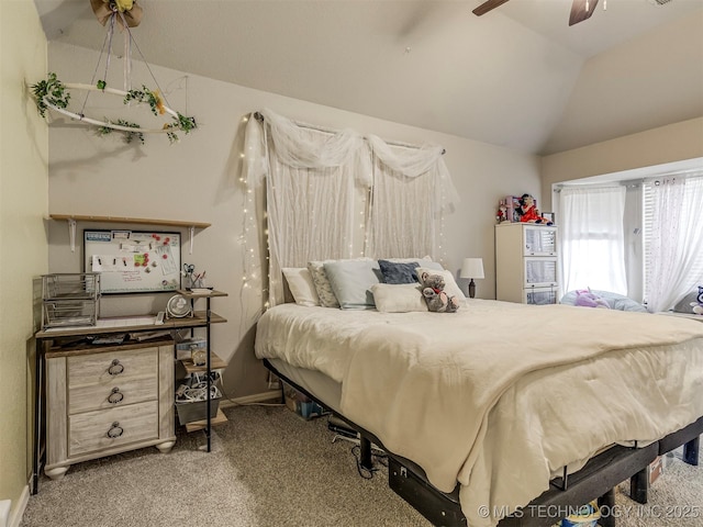 carpeted bedroom with ceiling fan, baseboards, and vaulted ceiling