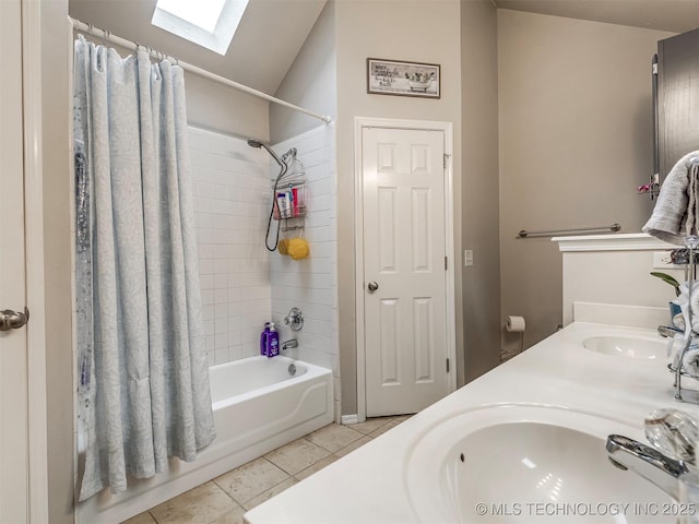 full bath featuring a skylight, a sink, tile patterned flooring, and shower / tub combo with curtain