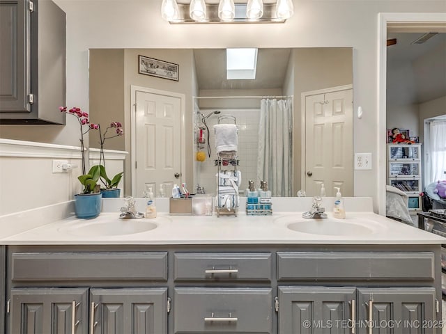 bathroom featuring double vanity, visible vents, and a sink