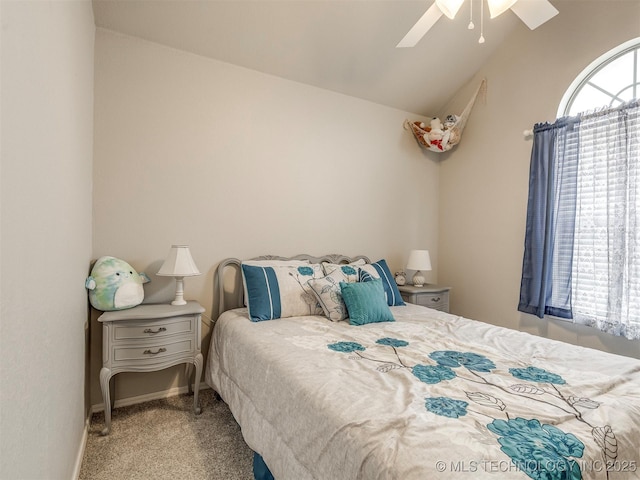 bedroom with vaulted ceiling, carpet flooring, and a ceiling fan