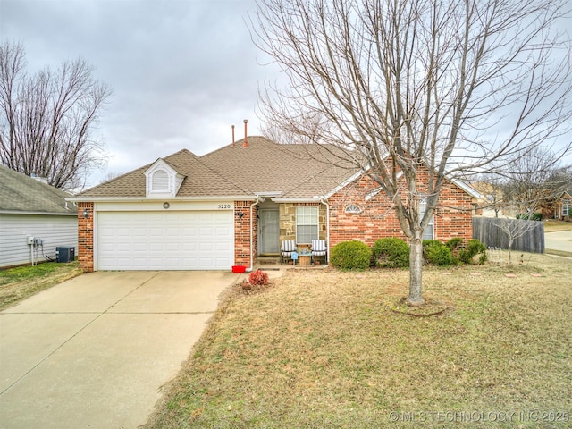 ranch-style home featuring driveway, central air condition unit, an attached garage, and brick siding