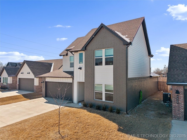 view of front facade with driveway, brick siding, cooling unit, and fence