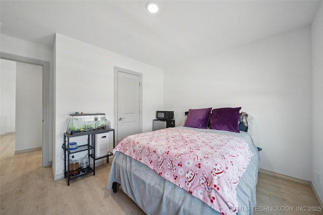 bedroom featuring light wood-type flooring, baseboards, and recessed lighting