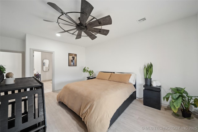 bedroom featuring a ceiling fan, light wood-type flooring, and visible vents