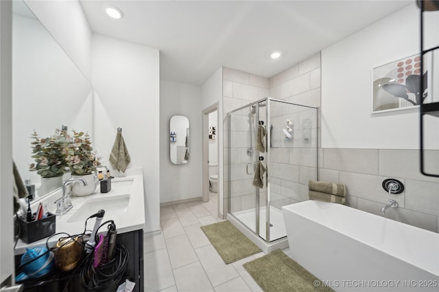 4632 S Chestnut Ave, Broken Arrow, OK 74011 - bathroom with a freestanding tub, toilet, a stall shower, double vanity, and recessed lighting