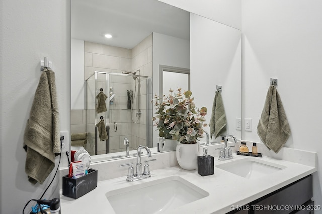 full bathroom featuring a sink, a shower stall, and double vanity